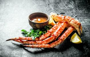 Crab with sauce, herbs and lemon. photo