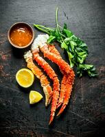 Boiled crab with herbs, sauce and sliced lemon. photo