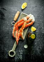 Crab on a cutting Board with beer and lemon slices. photo