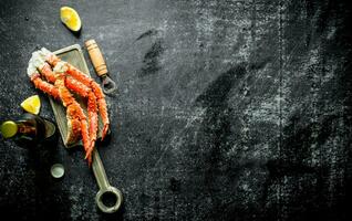 Crab on a cutting Board with beer and lemon slices. photo