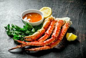 Fresh crab with lemon slices, parsley and sauce. photo