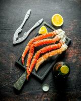 Crab on a cutting Board with a bottle of beer and slices of lemon. photo