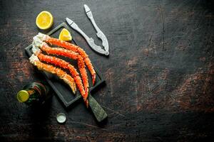 Crab on a cutting Board with a bottle of beer and slices of lemon. photo