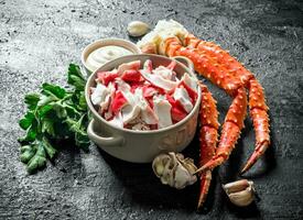 Crab meat with parsley, garlic cloves and sauce. photo