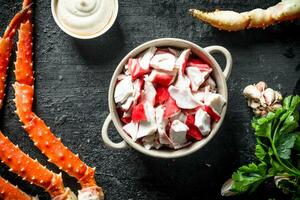 Crab meat with parsley, garlic cloves and sauce. photo