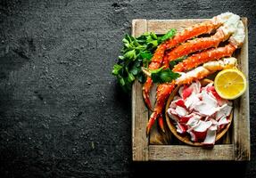 Crab meat and sea crab on tray with lemon and parsley. photo