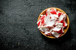 Crab meat on a wooden plate. photo