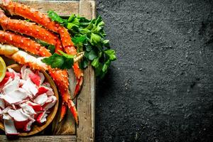 Crab meat and boiled crab on tray with greens. photo