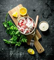 Crab meat with parsley, lemon slices and sauce. photo