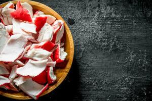 Crab meat on a wooden plate. photo