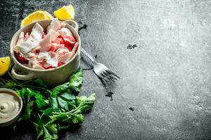 Crab meat with parsley, lemon slices and sauce. photo