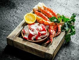 Crab meat and sea crab on tray with lemon and parsley. photo