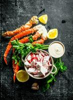 Crab meat and fresh crab with lemon slices, parsley and sauce. photo