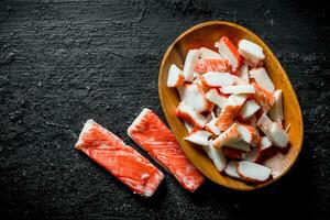 Sliced crab sticks on a plate. photo