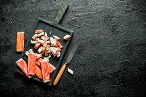 Sliced crab sticks on a cutting Board. photo