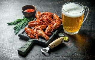 Boiled crayfish with beer, dill and sauce. photo
