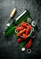 Hot spicy boiled crayfish with a bottle of beer and spices. photo