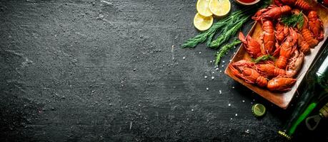 Boiled crayfish with beer, lemon slices and dill. photo