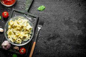 Dumplings with garlic cloves and spinach leaves. photo