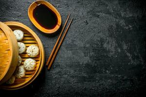 Traditional food. Dumplings manta in a bamboo steamer. photo