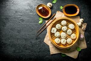 Traditional food. Dumplings manta with soy sauce in bowls. photo