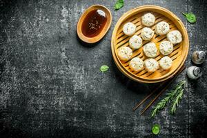 Hot manta dumplings with rosemary and soy sauce. photo