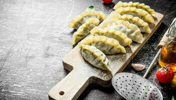 Raw gedza dumplings with beef. photo