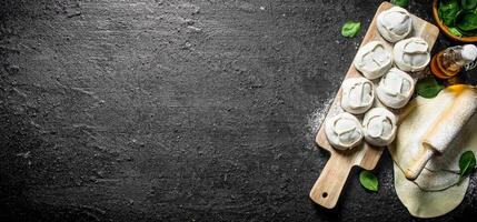 Raw manta dumpling on cutting Board. photo