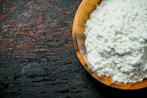 Wheat flour in bowl. photo