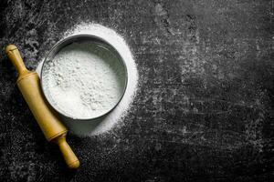 Flour with rolling pin and sieve. photo