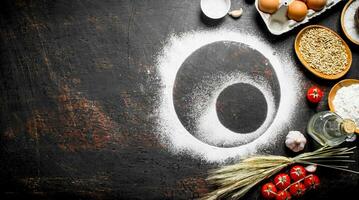 Round frames of flour with tomatoes, spikelets and eggs. photo