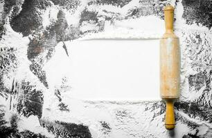 Texture of wheat flour with rolling pin. photo