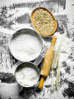 Flour in different sieve with grain, rolling pin and spikelets. photo