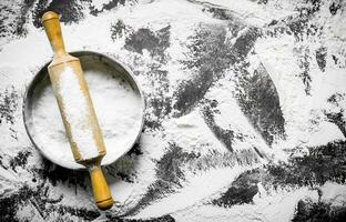 Flour with rolling pin and sieve. photo