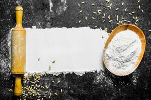 Flour with grain and rolling pin. photo