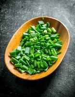 Chopped green onion on a plate. photo