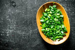 Chopped green onion on a plate. photo