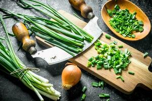 Green onion sliced on a cutting Board with onion. photo