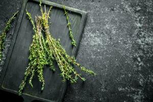 Fresh thyme on the cutting Board. photo