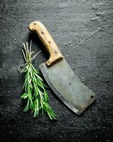 Bunch of fresh rosemary with a big knife. photo