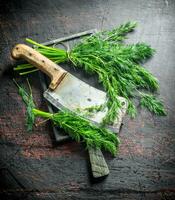 Fresh dill on a cutting Board with a knife. photo