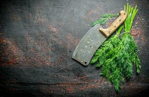 Bunch of fresh dill with a knife. photo