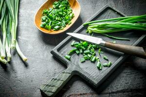 Chopped green onion on a cutting Board. photo