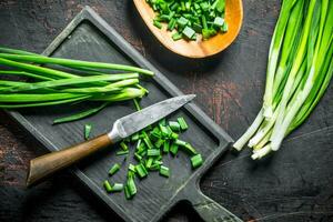 Chopped green onion on a cutting Board. photo