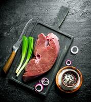 Raw liver with spices and green onion. photo