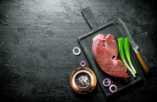 Raw liver with spices and green onion. photo