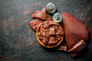 Pieces of raw liver with spices. photo