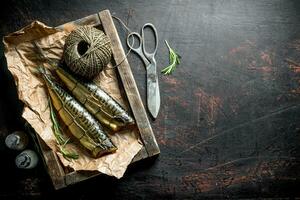 Delicious smoked mackerel on a tray with twine and spices. photo