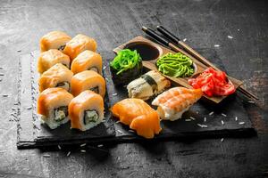 Set of different kinds of sushi rolls with salmon. photo