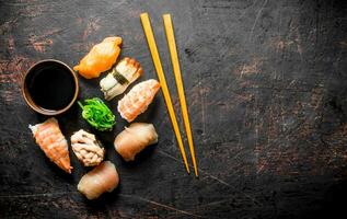 Different sushi with soy sauce and chopsticks. photo